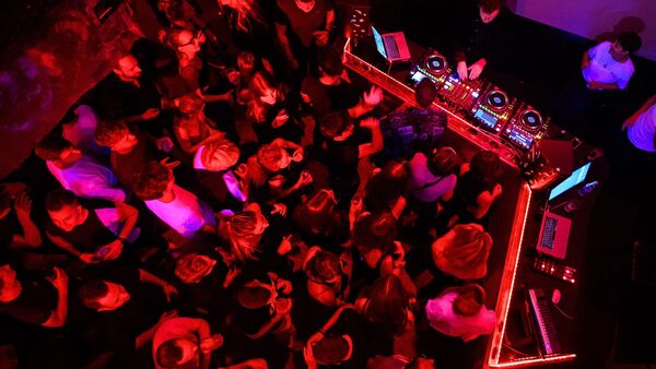 Menschen tanzen in einem Club zu elektronischer Musik., © Matthias Balk/dpa/Symbolbild